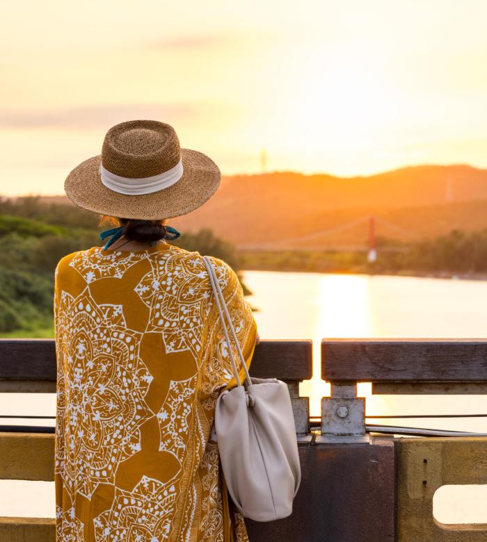 Travel woman enjoy the sunset over the sea view